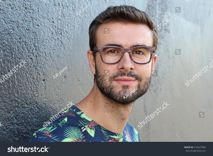 stock-photo-young-guy-with-a-beard-and-mustache-with-glasses-in-a-flowered-or-floral-shirt-posing-on-the-street-516437806